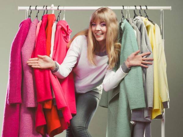 Woman Choosing Clothes To Wear In Mall Or Wardrobe